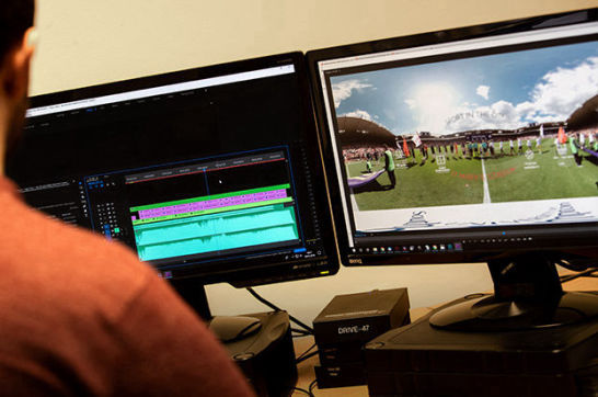 Technician processing 360° marketing video on multiple computer screens